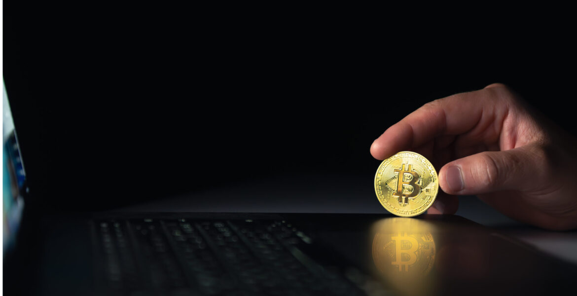 bitcoin-coin-near-laptop-black-background-finance-crypto-money-concept تحليل سعر سولانا (SOL)